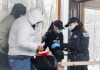 RCMP officers checks the credentials of two people who entered Canada via Roxham road on the Canada/US border in Hemmingford, Que., Saturday, March 25, 2023. THE CANADIAN PRESS/Graham Hughes