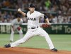 FILE - Japan's starter Tomoyuki Sugano pitches against Cuba during the first inning of their second round game at the World Baseball Classic at Tokyo Dome in Tokyo, on March 14, 2017. (AP Photo/Toru Takahashi, File)