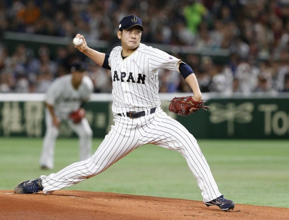 FILE - Japan's starter Tomoyuki Sugano pitches against Cuba during the first inning of their second round game at the World Baseball Classic at Tokyo Dome in Tokyo, on March 14, 2017. (AP Photo/Toru Takahashi, File)