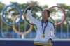 FILE -Lydia Ko, of New Zealand, waves to the crowd wearing her gold medal during the medal ceremony following the final round of the women's golf event at the 2024 Summer Olympics, Saturday, Aug. 10, 2024, at Le Golf National, in Saint-Quentin-en-Yvelines, France. (AP Photo/Matt York, File)