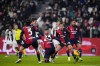 Juventus' Dusan Vlahovic, front second left, scores the opening goal during the round of sixteen Coppa Italia soccer match between Juventus Turin and Cagliari Calcio in Turin, Italy, Tuesday, Dec. 17, 2024. (Fabio Ferrari/LaPresse via AP)