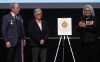 Governor General Mary Simon, right, applauds founder and co-chair Diane Pitre, centre, and co-chair Todd Ross of Rainbow Veterans of Canada following the unveiling of a heraldic badge, Friday, April 19, 2024 at the Canadian War Museum in Ottawa. More than 40 years after being told she was a threat to Canada because of her sexuality, Diane Pitre is being given one of the country's top honours. THE CANADIAN PRESS/Adrian Wyld