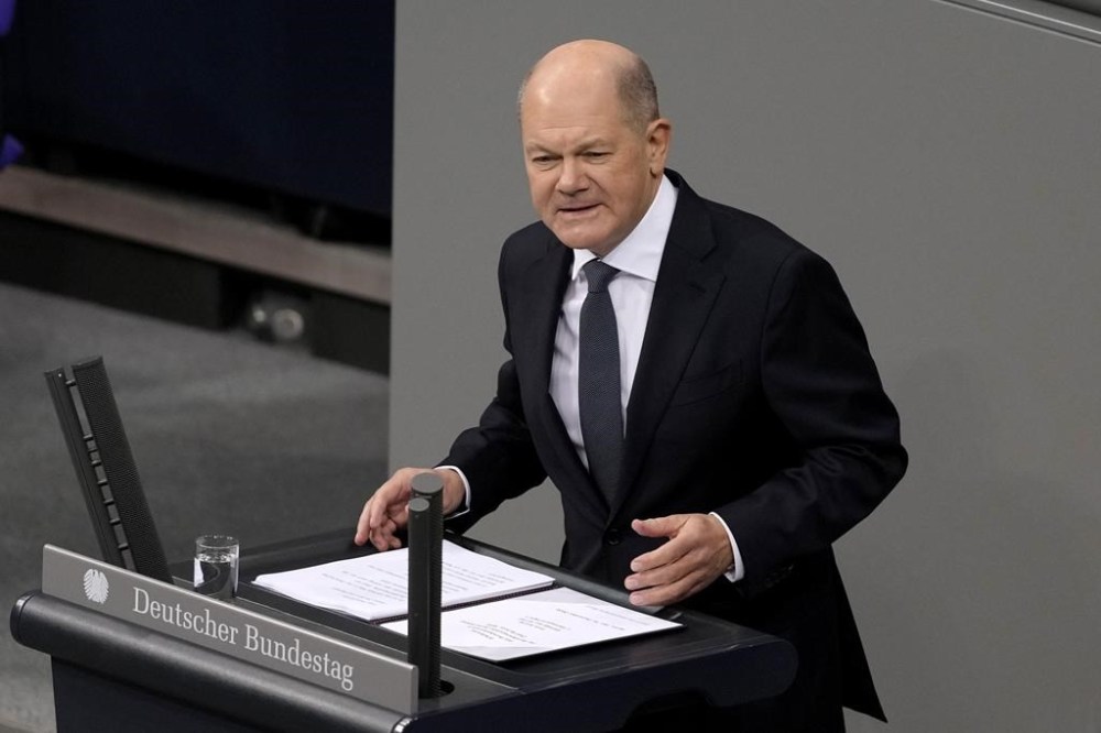 FILE - German Chancellor Olaf Scholz speaks during a plenary session at the German parliament Bundestag where he faces a vote of confidence, in Berlin, Dec. 16, 2024. (AP Photo/Markus Schreiber, File)