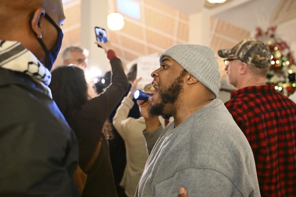 A protester reacts as the Republican-dominated North Carolina House convened to complete the override of Democratic Gov. Roy Cooper's veto of a bill that aims to weaken the powers of Cooper's soon-to-be successor and other Democratic statewide winners in the Nov. 5 elections, Wednesday, Dec. 11, 2024, in Raleigh, N.C. (AP Photo/Matt Kelley)