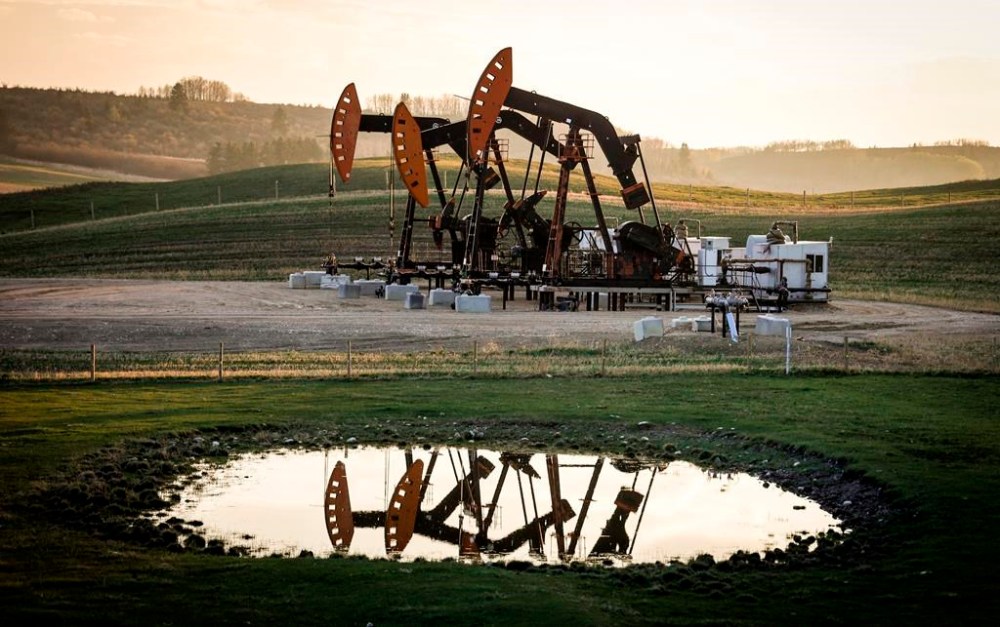 FILE - Pumpjacks draw out oil and gas from well heads as wildfire smoke hangs in the air near Calgary, Alberta, May 12, 2024. (Jeff McIntosh/The Canadian Press via AP, File)