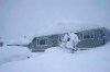 Environment Canada has issued another wind warning for exposed coastal sections of north Vancouver Island and B.C.'s central coast. Snow covers the roof of a house in Kitimat, B.C. after a heavy snowstorm on Friday Feb. 6, 2015. THE CANADIAN PRESS/Robin Rowland