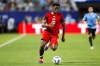 Canada forward Jonathan David moves the ball during the Copa America third place soccer match against Uruguay in Charlotte, N.C., Saturday, July 13, 2024. Moïse Bombito, David and Alistair Johnston are the finalists for Canada Soccer Player of the Year. THE CANADIAN PRESS/AP/Nell Redmond