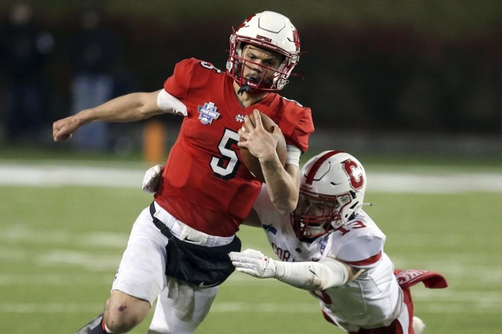 FILE - North Central quarterback Luke Lehnen (5) runs for a touchdown past Cortland defender Luke Winslow (13) during the second half of the Amos Alonzo Stagg Bowl NCAA Division III championship football game in Salem, Va., Friday Dec. 15, 2023. (Matt Gentry/The Roanoke Times via AP, File)