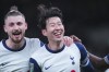 Tottenham's Son Heung-min, right, celebrates after scoring his side's fourth goal during the English League Cup quarter-final soccer match between Tottenham and Manchester United, at the Tottenham Hotspur Stadium in London, Thursday, Dec. 19, 2024. (AP Photo/Dave Shopland )