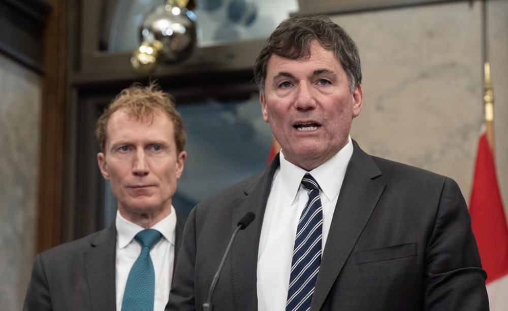 Immigration, Refugees and Citizenship Minister Marc Miller looks on as Minister of Public Safety, Democratic Institutions and Intergovernmental Affairs and Finance Minister Dominic LeBlanc speaks during an availability in Ottawa, Tuesday, Dec. 17, 2024. THE CANADIAN PRESS/Adrian Wyld