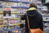 Business groups say the tax holiday is on track to boost sales for retailers and restaurant owners, even though some have struggled to implement the temporary deal. Customers browse products at a Game Stop store next to a sign advertising 