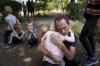 FILE - A father hugs his daughter, his other children nearby, as they wait for evacuation in Pokrovsk, Donetsk region, Ukraine, Friday, Aug. 23, 2024. (AP Photo/Evgeniy Maloletka, File)