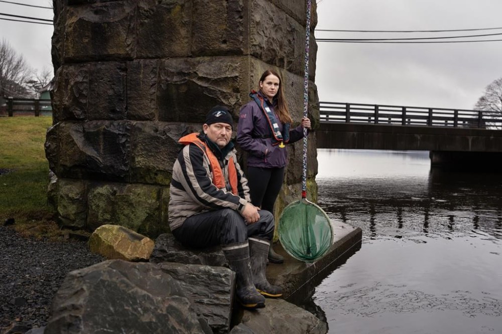 Elver fishers Mark Weldon, left, and Suzy Edwards pose at one of their fishing spots on the Sackville River in Halifax on Thursday, December 19, 2024. THE CANADIAN PRESS/Darren Calabrese