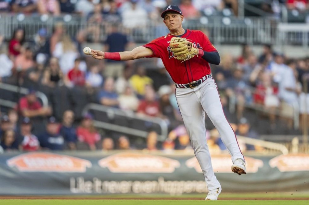 FILE - Atlanta Braves third baseman Gio Urshela throws out a Washington Nationals runner at first base in the first inning of a baseball game Friday, Aug. 23, 2024, in Atlanta. (AP Photo/Jason Allen, File)
