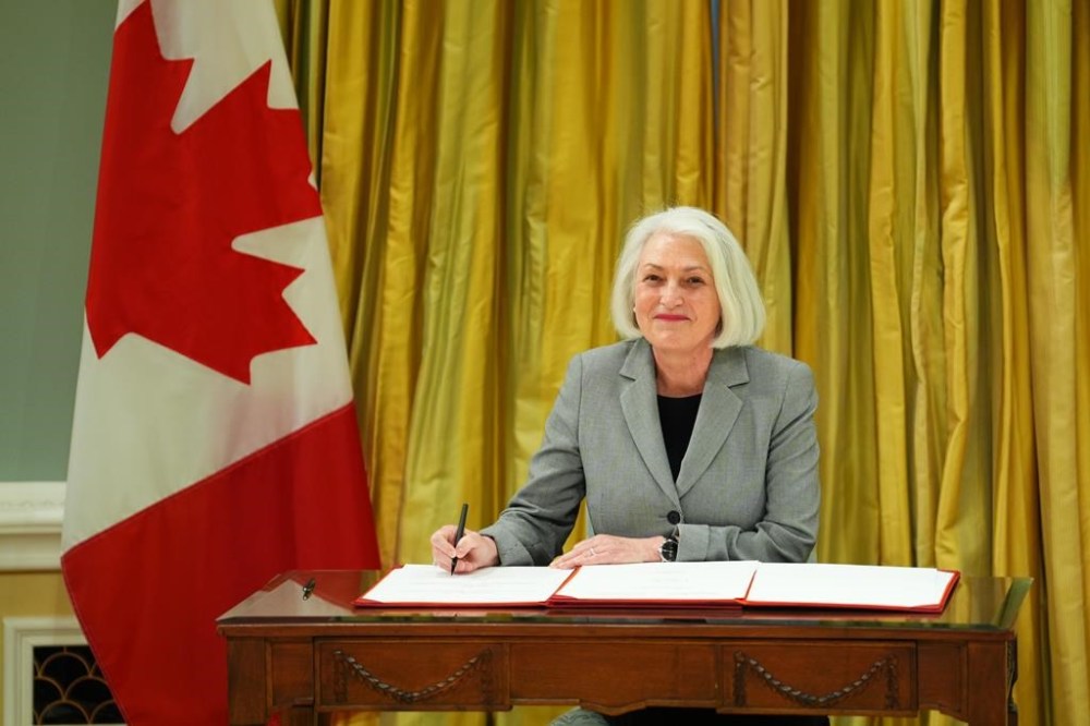 Minister of Seniors Joanne Thompson signs a document during a cabinet swearing-in ceremony at Rideau Hall in Ottawa, on Friday, Dec.20, 2024. THE CANADIAN PRESS/Sean Kilpatrick