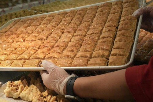 Baklava is put into a display counter at the bakery in the Adonis grocery store in Mississauga, Ont. on Monday, December 16, 2024. THE CANADIAN PRESS/Chris Young