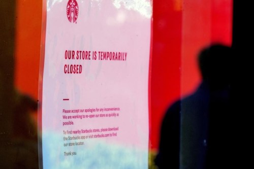 A closed store sign is seen in the window of a Starbucks as workers picket outside the location on company Friday, Dec. 20, 2024, in Burbank, Calif. (AP Photo/Damian Dovarganes)