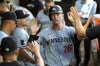 FILE -Minnesota Twins' Max Kepler (26) is greeted in the dugout after scoring off a double by Byron Buxton during the fourth inning of a baseball game against the Chicago White Sox, Monday, July 8, 2024, in Chicago. (AP Photo/Charles Rex Arbogast, File)