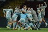 Atletico Madrid players celebrate their victory goal during the Spanish La Liga soccer match between Barcelona and Atletico Madrid at the Lluis Companys Olympic Stadium in Barcelona, Spain, Saturday, Dec. 21, 2024. (AP Photo/Joan Monfort)