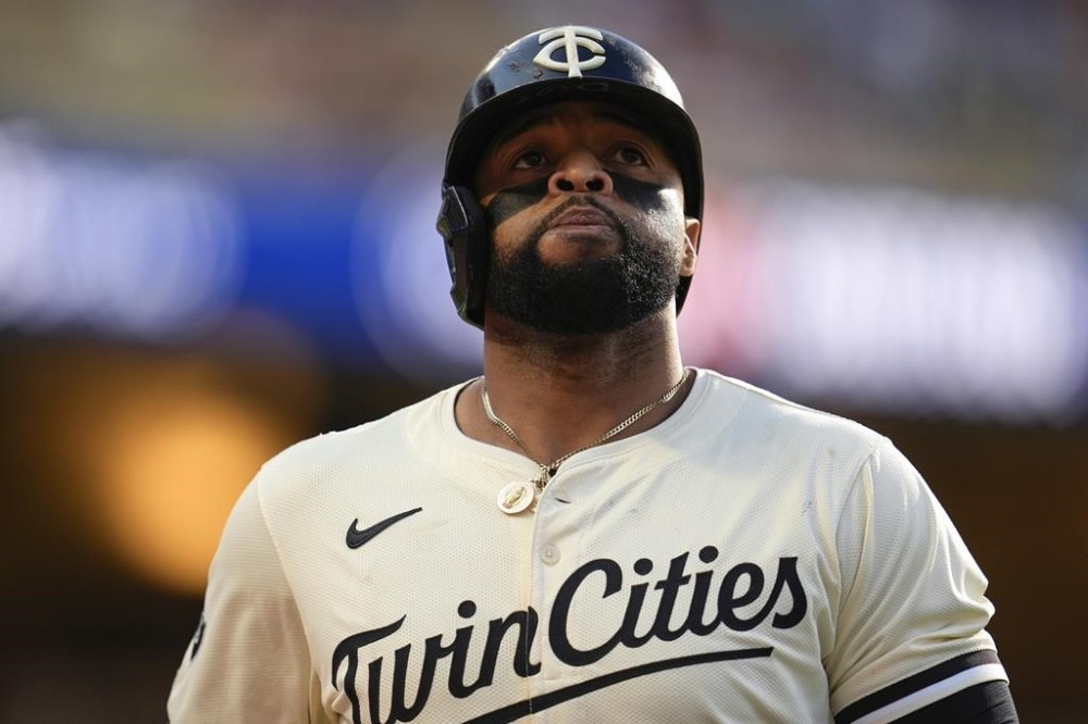 FILE - Minnesota Twins' Carlos Santana walks back to the dugout after hitting a line out to right during the ninth inning of a baseball game against the Baltimore Orioles, Sept. 29, 2024, in Minneapolis. (AP Photo/Abbie Parr, File)