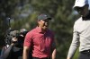 Tiger Woods, center, reacts to his son Charlie Wood's hole-in-one on the fourth hole during the final round of the PNC Championship golf tournament, Sunday, Dec. 22, 2024, in Orlando, Fla. (AP Photo/Phelan M. Ebenhack)