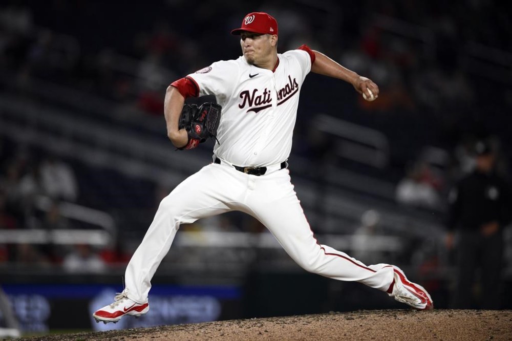 FILE - Washington Nationals relief pitcher Robert Garcia (61) in action during a baseball game against the Colorado Rockies, Aug. 20, 2024, in Washington. (AP Photo/Nick Wass, File)