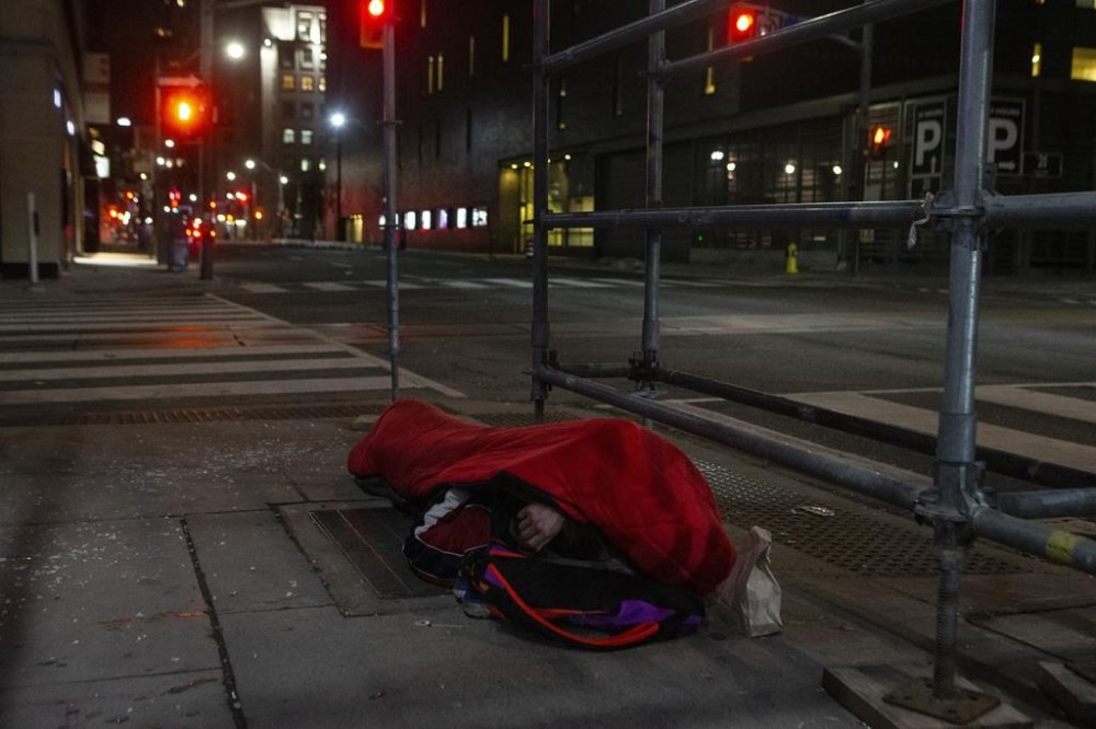 As the province seeks to end homeless encampments in public spaces with tough new legislation, many Ontarians are divided over how the issue should be handled amid ongoing housing, addictions and mental-health crises. A man sleeps on the street in Toronto on, March 11, 2022. THE CANADIAN PRESS/Chris Young
