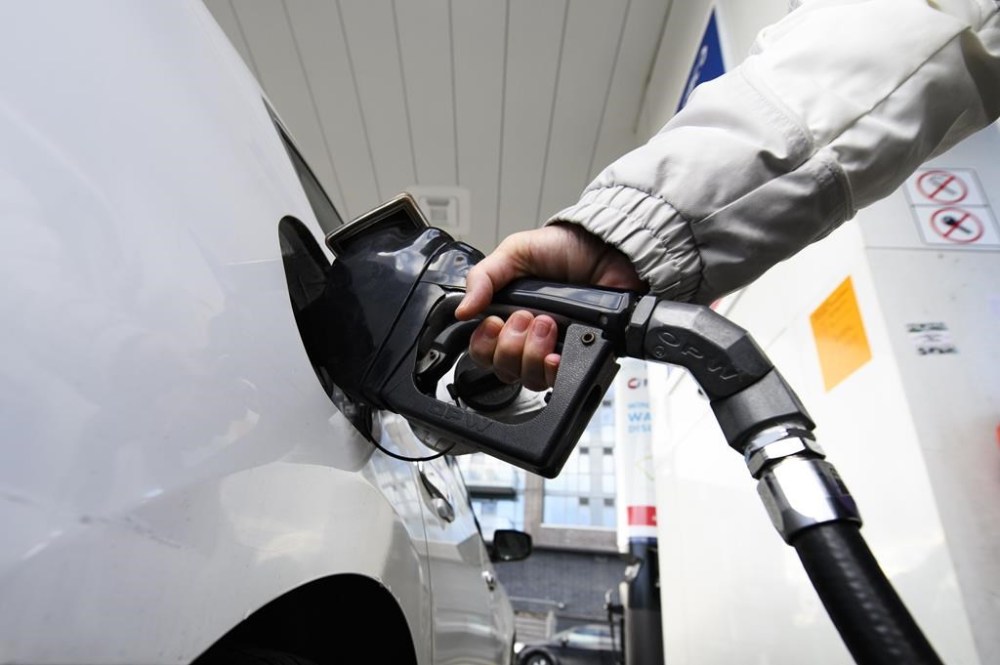 The Manitoba government is ending its yearlong fuel tax holiday but bringing back the levy at a lower rate. A person pumps gas at a gas station in Mississauga, Ont., Tuesday, Feb.13, 2024. THE CANADIAN PRESS/Christopher Katsarov