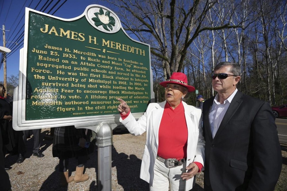 Judy Alsobrooks Meredith, wife of James Meredith, who became the first Black student to enroll at the University of Mississippi in 1962, left, and Kosciusko Mayor Tim Kyle, review the Mississippi Department of Archives and History marker recognizing Meredith's birthplace and his legacy in Kosciusko, Miss., Friday, Dec. 20, 2024. (AP Photo/Rogelio V. Solis)