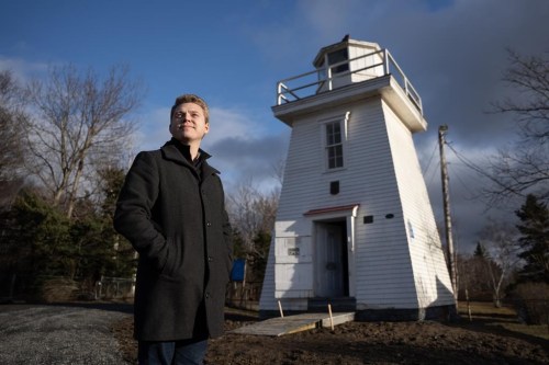 John Ogilvie, climate action co-ordinator for the Municipality of East Hants, stands outside the Walton Harbour Lighthouse that had to be moved from its original location due to coastal erosion in Walton, N.S. on Thursday, December 19, 2024. THE CANADIAN PRESS/Darren Calabrese