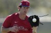 FILE - Philadelphia Phillies Andrew Painter fields a ground ball during a spring training baseball workout, Feb. 21, 2023, in Clearwater, Fla. (AP Photo/David J. Phillip, File)
