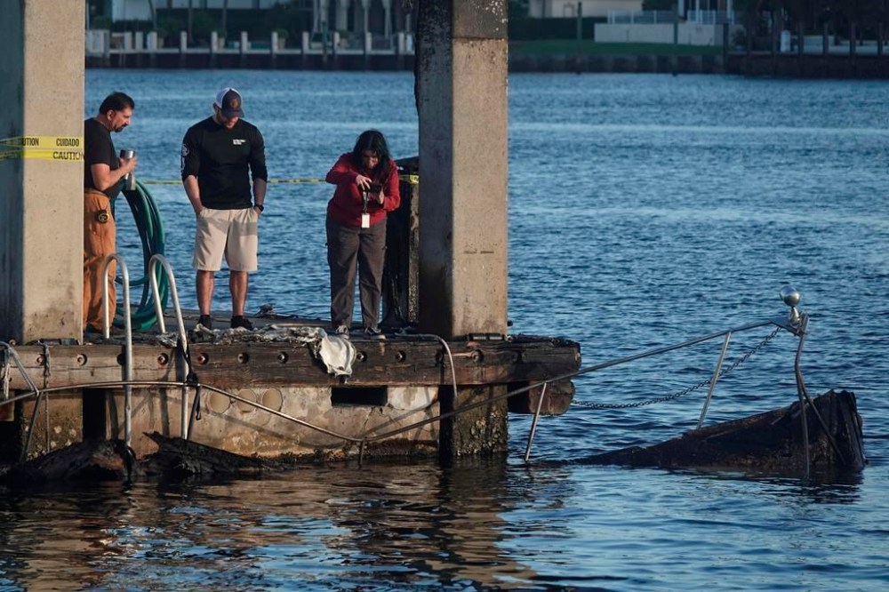 The charred remains of two boats are seen Tuesday, Dec. 24, 2024, at Lauderdale Marina near the 15th Street Fisheries restaurant in Fort Lauderdale, Fla., Wednesday, Dec. 25, 2024. THE CANADIAN PRESS/AP-South Florida Sun-Sentinel, Joe Cavaretta