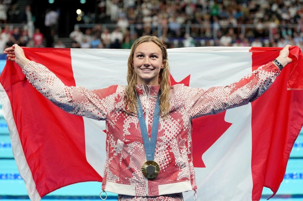 Canada's Summer McIntosh, of Toronto, celebrates with her gold medal won in the 200m women's individual medley final during the 2024 Summer Olympic Games, in Nanterre, France, Saturday, Aug. 3, 2024. THE CANADIAN PRESS/Christinne Muschi