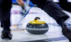A Winnipeg pilot project offers arena ice and rocks in a curling club to top teams in the area. Players sweep a rock at the Tim Hortons Brier in Lethbridge, Alta., Sunday, March 6, 2022. THE CANADIAN PRESS/Jeff McIntosh