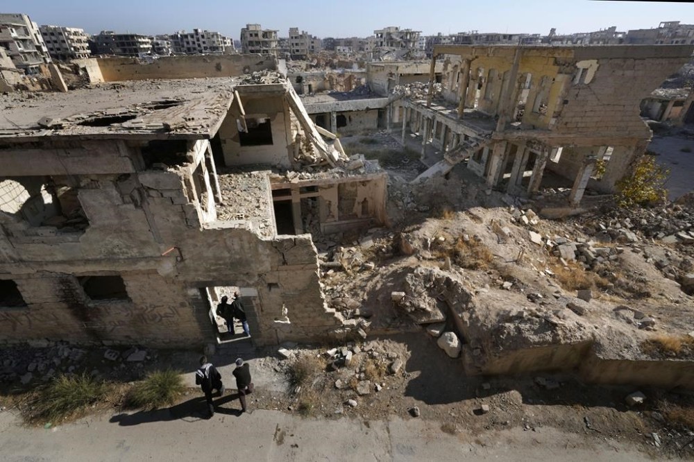 Syrian citizens check the destroyed Jobar Synagogue, also known as Eliyahu Hanavi, in Jobar neighborhood, in Damascus, Syria, Wednesday, Dec. 25, 2024. (AP Photo/Hussein Malla)