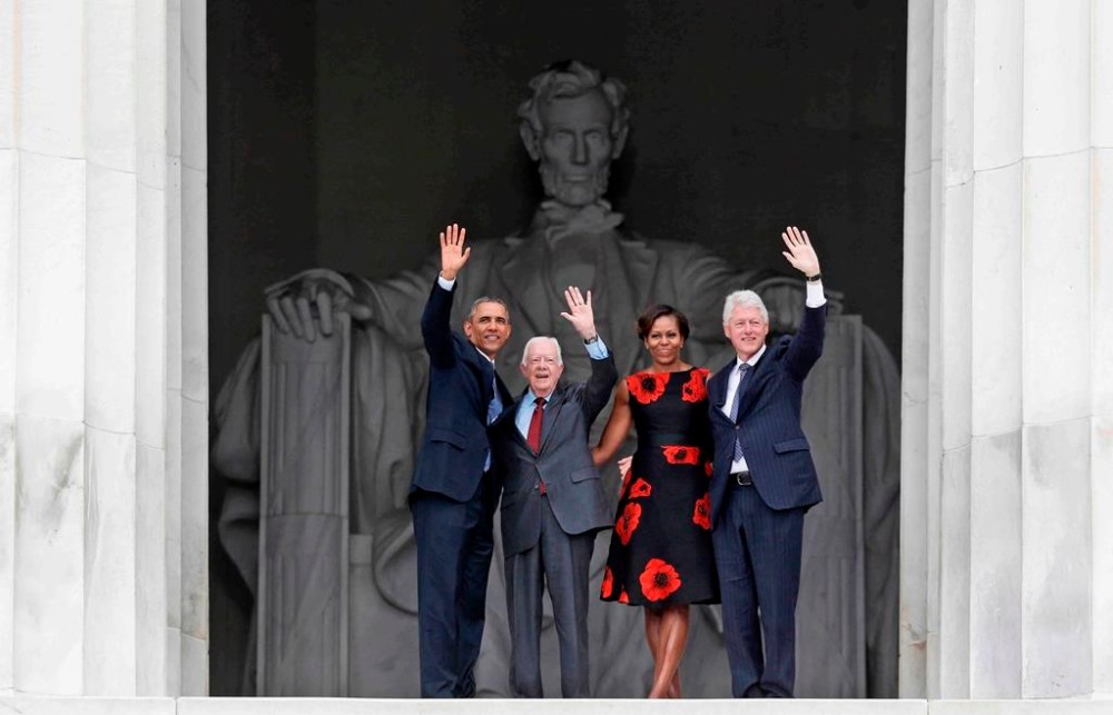 FILE - From left, President Barack Obama, former President Jimmy Carter, first lady Michelle Obama and former President Bill Clinton wave from the Lincoln Memorial in Washington during a celebration of the 50th anniversary of the March on Washington where Martin Luther King Jr. spoke, Aug. 28, 2013. (AP Photo/Charles Dharapak, File)