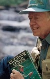 FILE - Former President Jimmy Carter holds a copy of his book, 