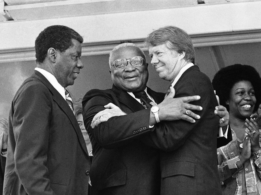FILE - The Rev. Dr. Martin Luther King Sr., center, and Democratic presidential candidate Jimmy Carter, right, embrace during a campaign rally where King declared,