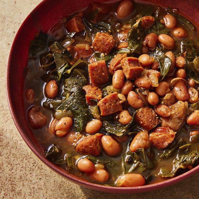 This image released by Milk Street shows a recipe for paprika-pinto bean soup with collard greens. (Milk Street via AP)