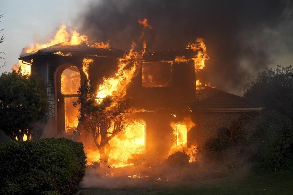 FILE - A fire burns a house in the Mountain fire, Wednesday, Nov. 6, 2024, in Camarillo, Calif. (AP Photo/Marcio Jose Sanchez, File)