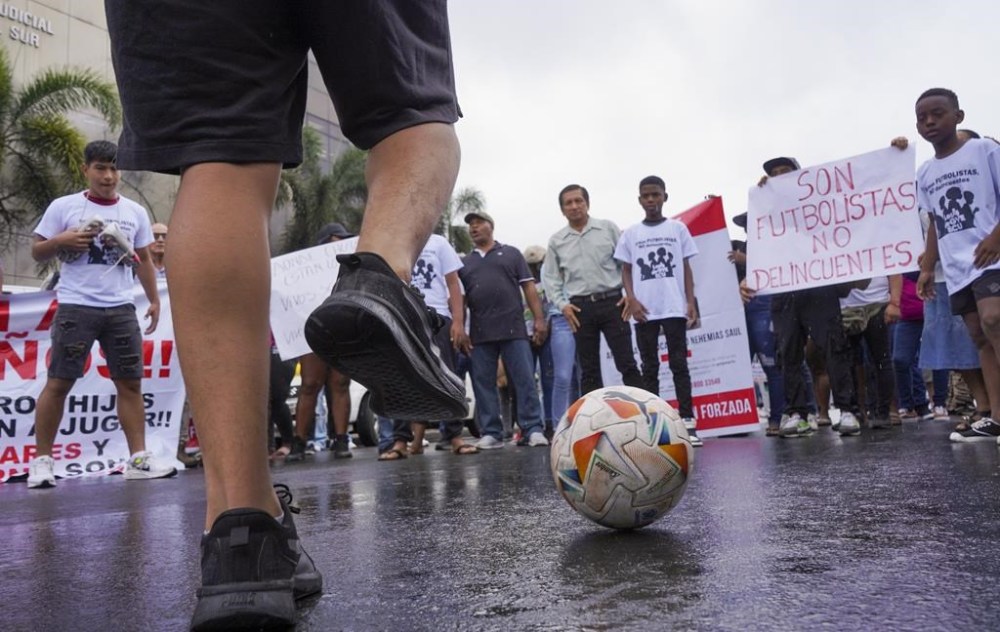 Protesters gather outside the court that is holding a hearing for the soldiers accused of being connected to the disappearance of four children in Guayaquil, Ecuador, Tuesday, Dec. 31, 2024. The children disappeared after playing soccer. (AP Photo/Cesar Munoz)