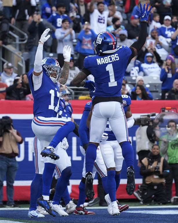New York Giants wide receiver Wan'Dale Robinson (17) celebrates with Malik Nabers (1) after Robinson scored a touchdown against the Indianapolis Colts in the first half of an NFL football game Sunday, Dec. 29, 2024, in East Rutherford, N.J. (AP Photo/Seth Wenig)