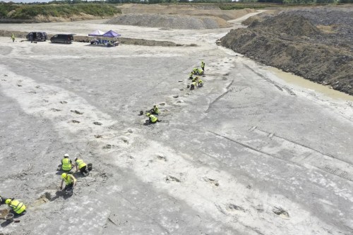 In this undated photo provided by the University of Birmingham on Thursday, Jan. 2, 2025, work underway as five extensive trackways that formed part of a “dinosaur highway” are uncovered, at Dewars Farm Quarry in Oxfordshire, England. (University of Birmingham via AP)