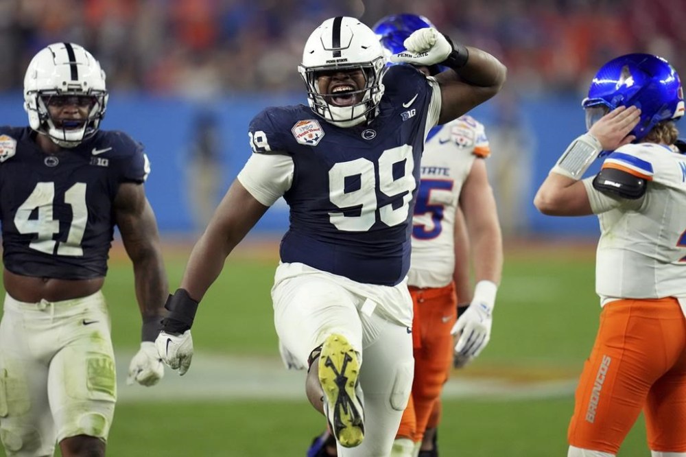 Penn State defensive tackle Coziah Izzard (99) celebrates a defensive stop against Boise State during the second half of the Fiesta Bowl College Football Playoff game, Tuesday, Dec. 31, 2024, in Glendale, Ariz. (AP Photo/Ross D. Franklin)