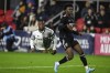 Toronto FC forward Ayo Akinola goes airborne after attempting a shot on goal against D.C. United defender Matai Akinmboni during the first half of an MLS soccer match, Saturday, Feb. 25, 2023, in Washington. (AP Photo/Terrance Williams, File)