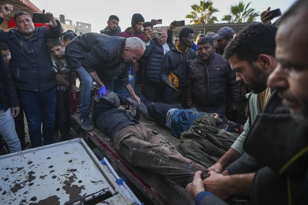 REMOVES NUMBER OF KILLED - The bodies of men killed in an Israeli army strike targeting a car are brought to Al-Aqsa Martyrs hospital in Deir al-Balah, central Gaza Strip, Friday, Jan. 3, 2025. (AP Photo/Abdel Kareem Hana)