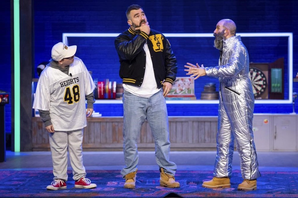 Former NFL player and ESPN analyst Jason Kelce, center, performs a skit with a younger and older version of himself during the taping of