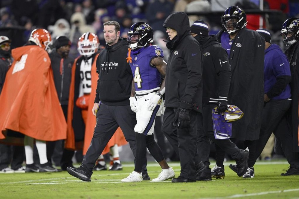 Baltimore Ravens wide receiver Zay Flowers is helped off the field after being injured during the first half of an NFL football game against the Cleveland Browns Saturday, Jan. 4, 2025, in Baltimore. (AP Photo/Nick Wass)