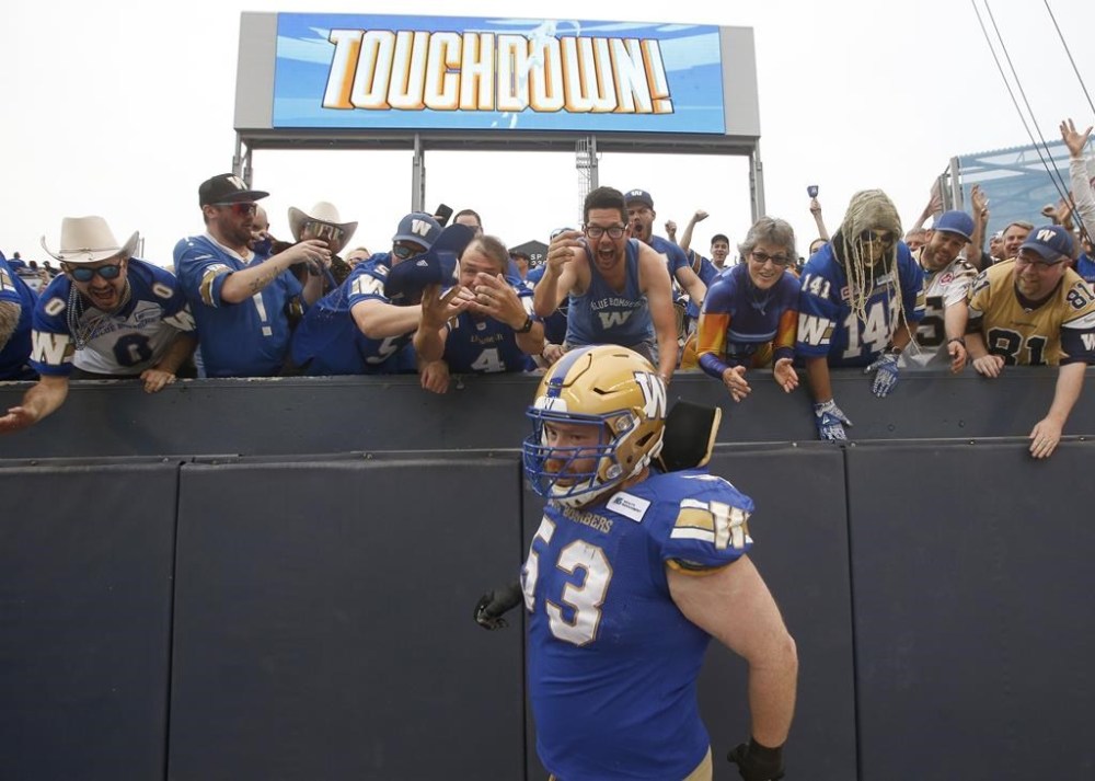Winnipeg Blue Bombers' Patrick Neufeld interacts with fans during first half CFL action against the Ottawa Redblacks in Winnipeg, Friday, June 10, 2022. THE CANADIAN PRESS/John Woods