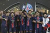 PSG players celebrate with a trophy after the French Super Cup final match between Paris Saint Germain and Monaco in Doha, Qatar, on Sunday, Jan. 5, 2025.(AP Photo/Hussein Sayed)